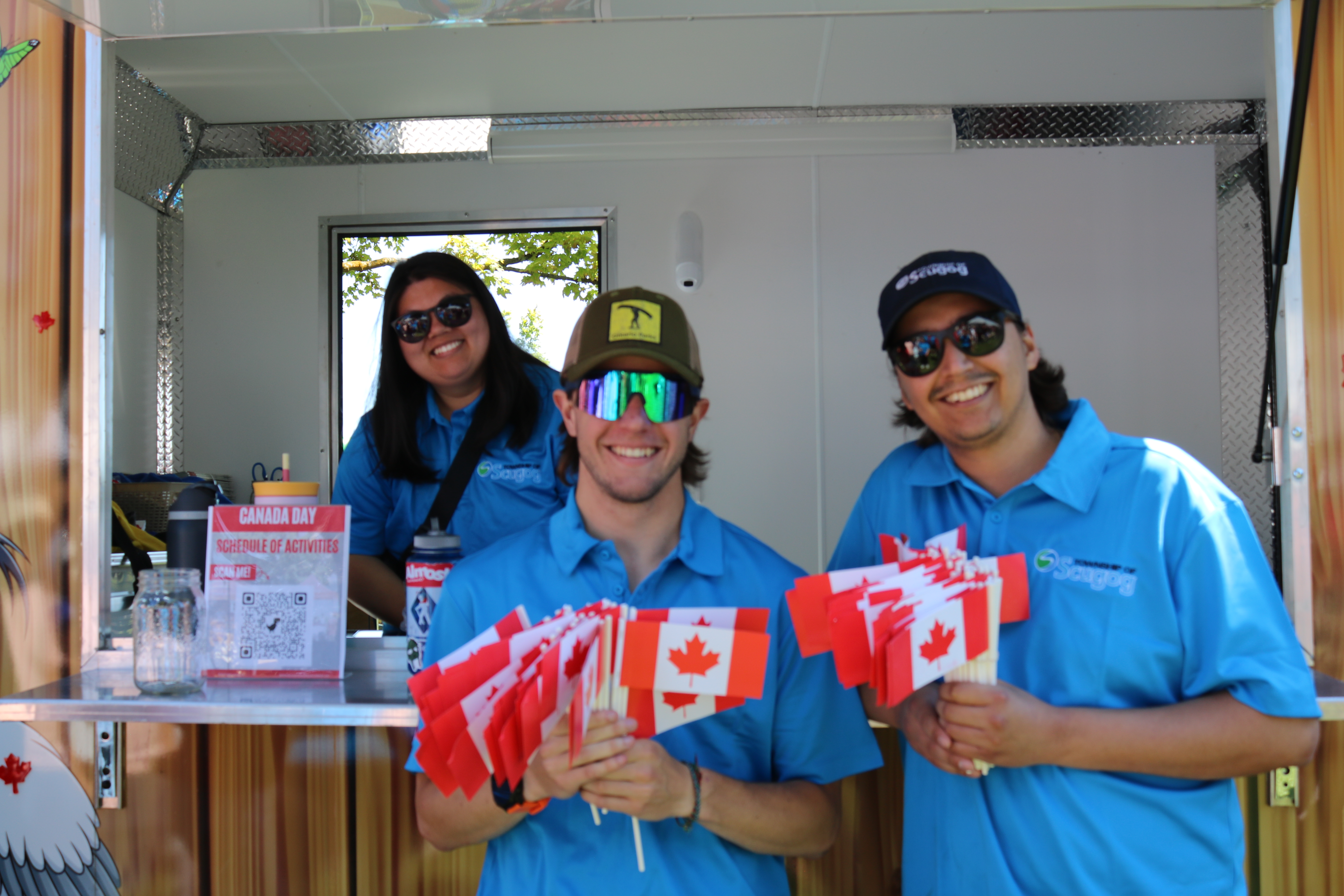 Photo of Township of Scugog staff holding Canada Day mini flags