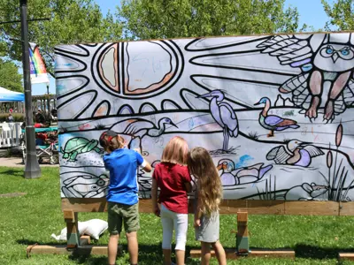 Photo of children colouring a large banner