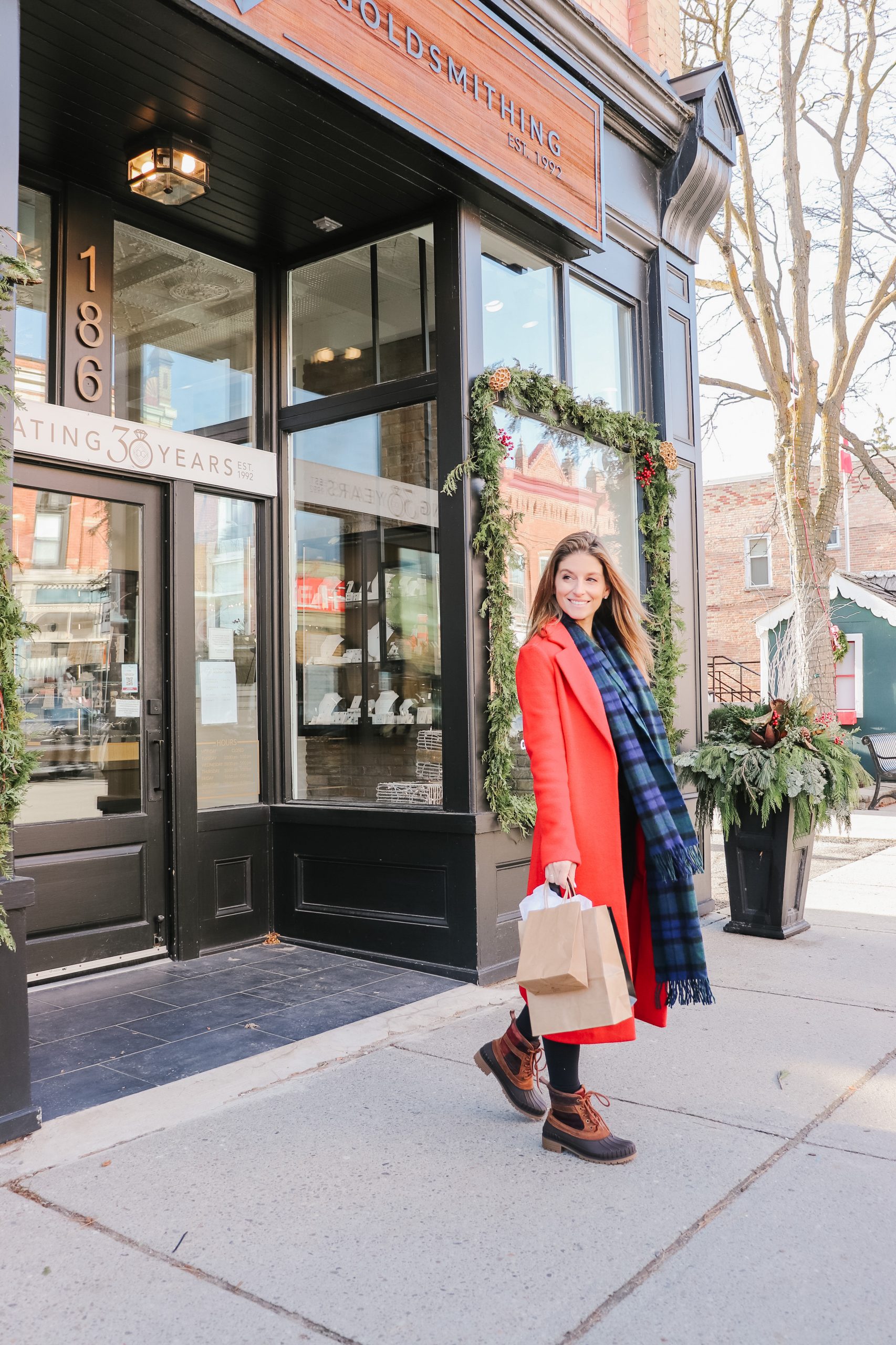 Woman walking out of store with bag in hand